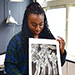 student holding artwork 